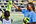 Coach Odessa deelt op Sint Maarten hesjes uit voor een voetbalwedstrijdje.
